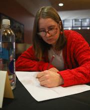 Olivia Dunn, '24, writing on a piece of paper during a Life Design session